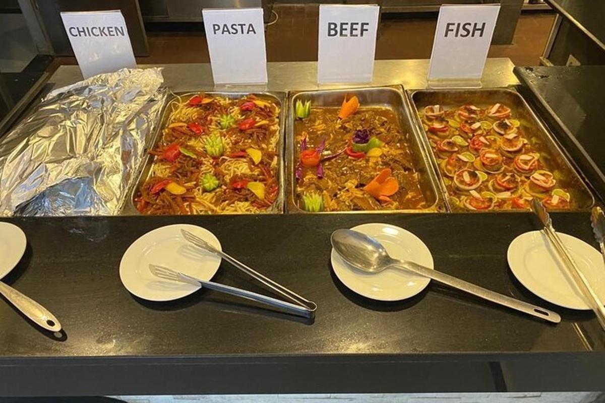 a buffet filled with different types of food with spoons