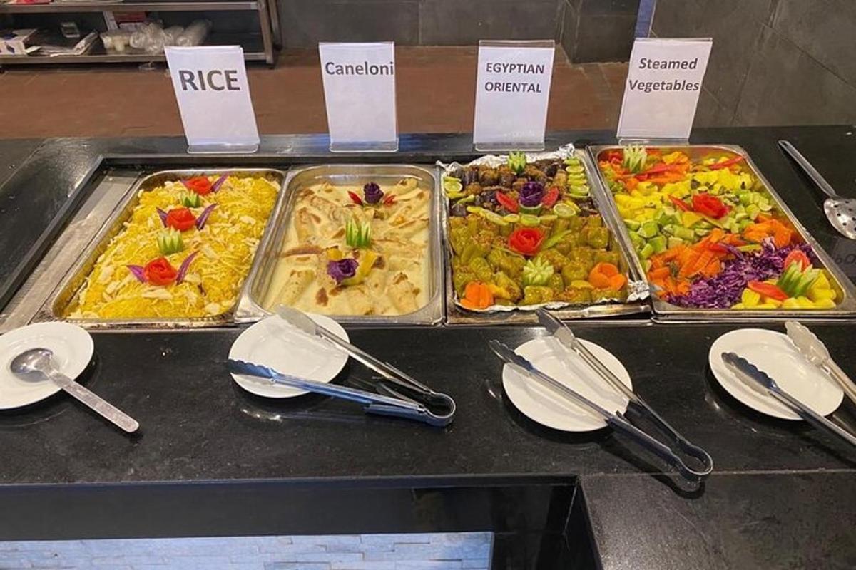 a buffet with several trays of food on a table