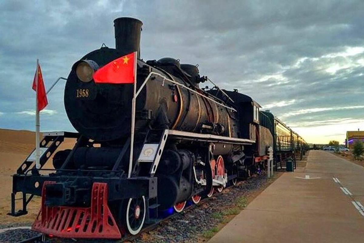 a black train is sitting on the tracks