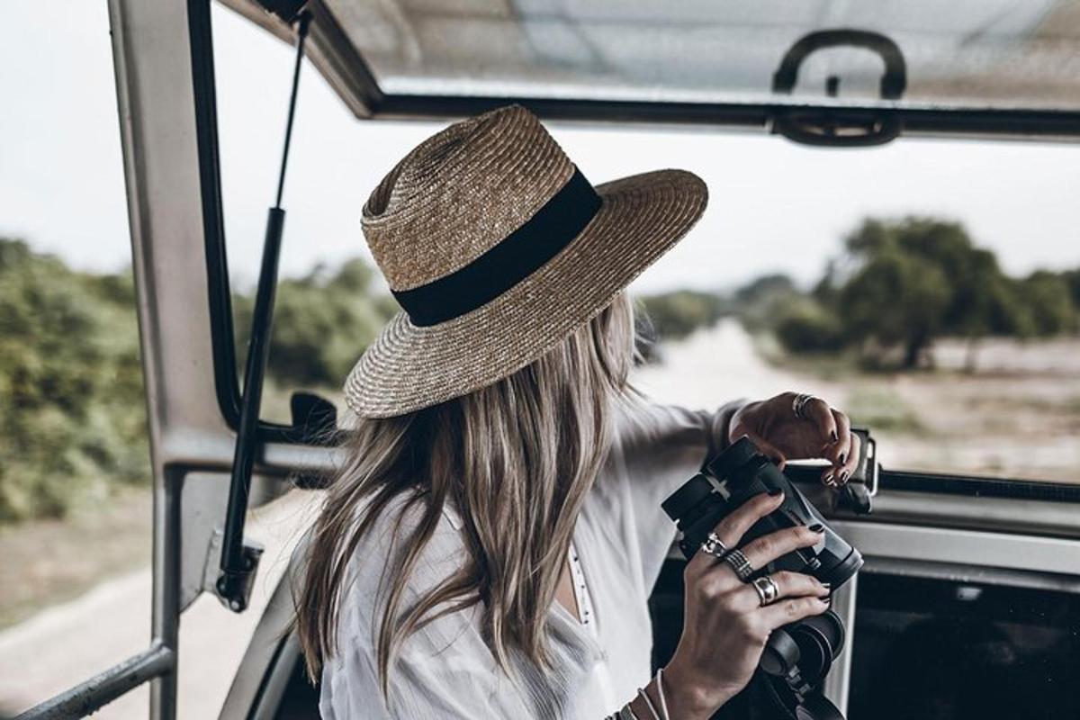 moteris su skrybėle fotografuojasi autobuse