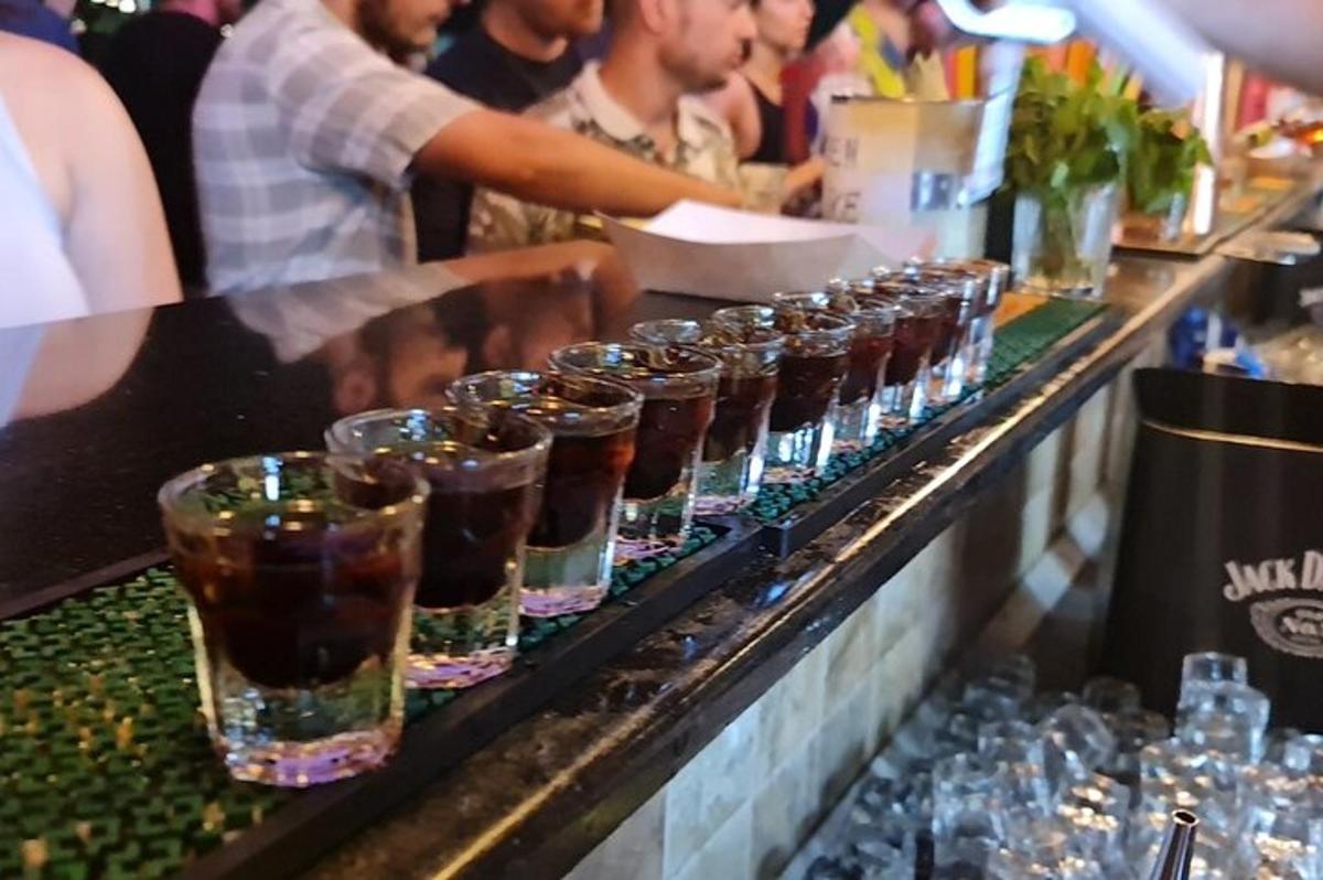 a bar with a row of glasses on a counter