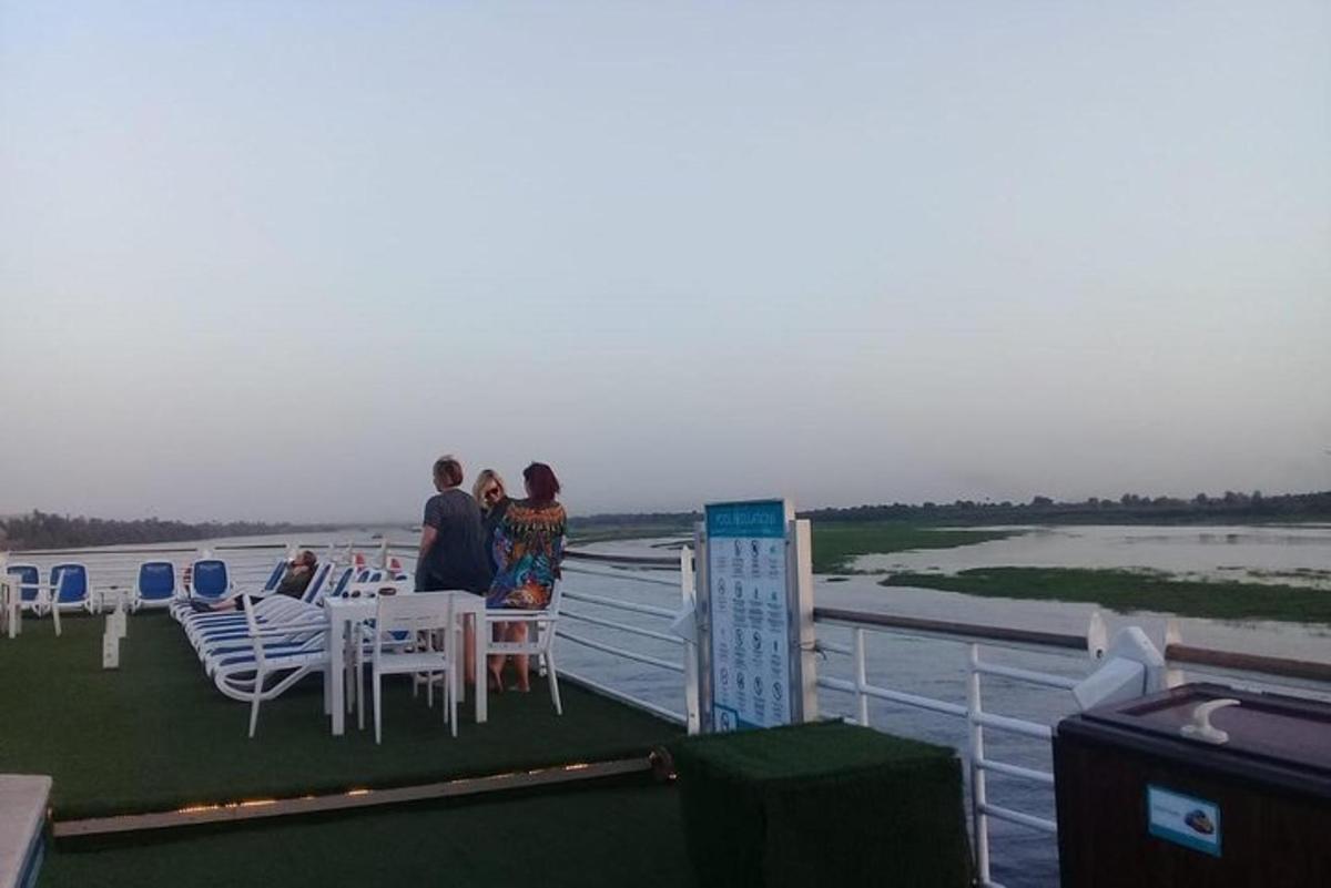 a group of people sitting at a table on a boat