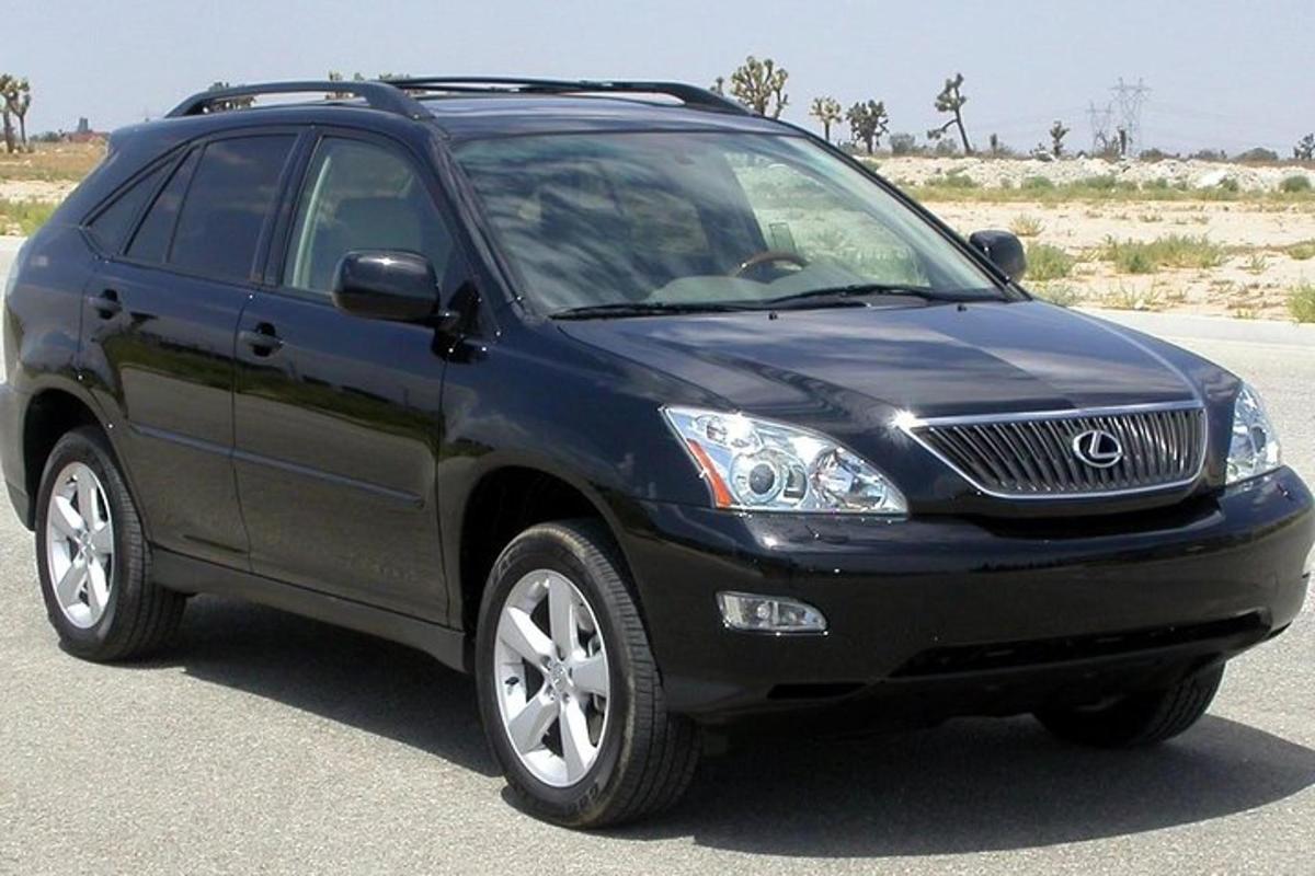 a blue lexus suv parked on a road