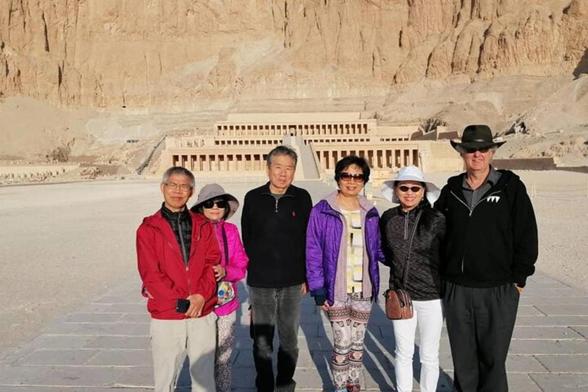 a group of people standing in front of the pyramids
