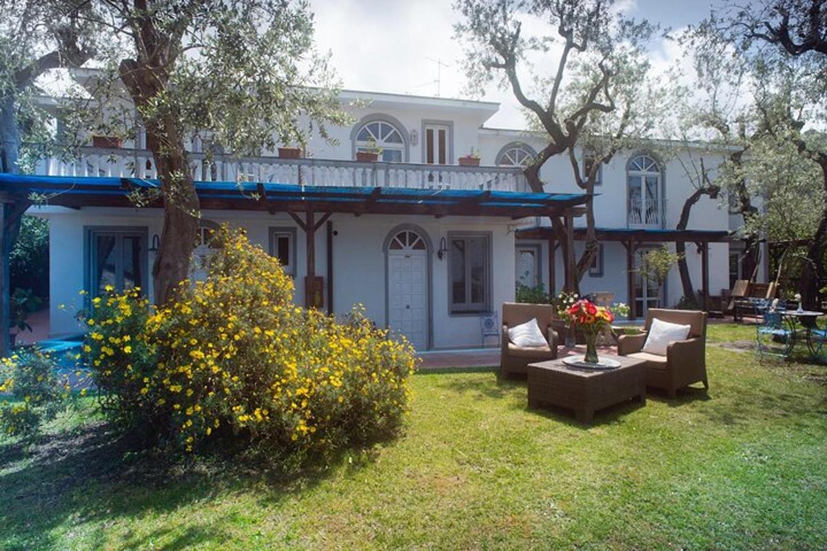 a white house with chairs and a table in a yard