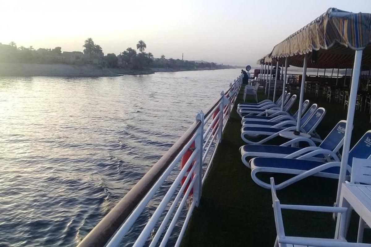 a row of chairs on a boat on the water