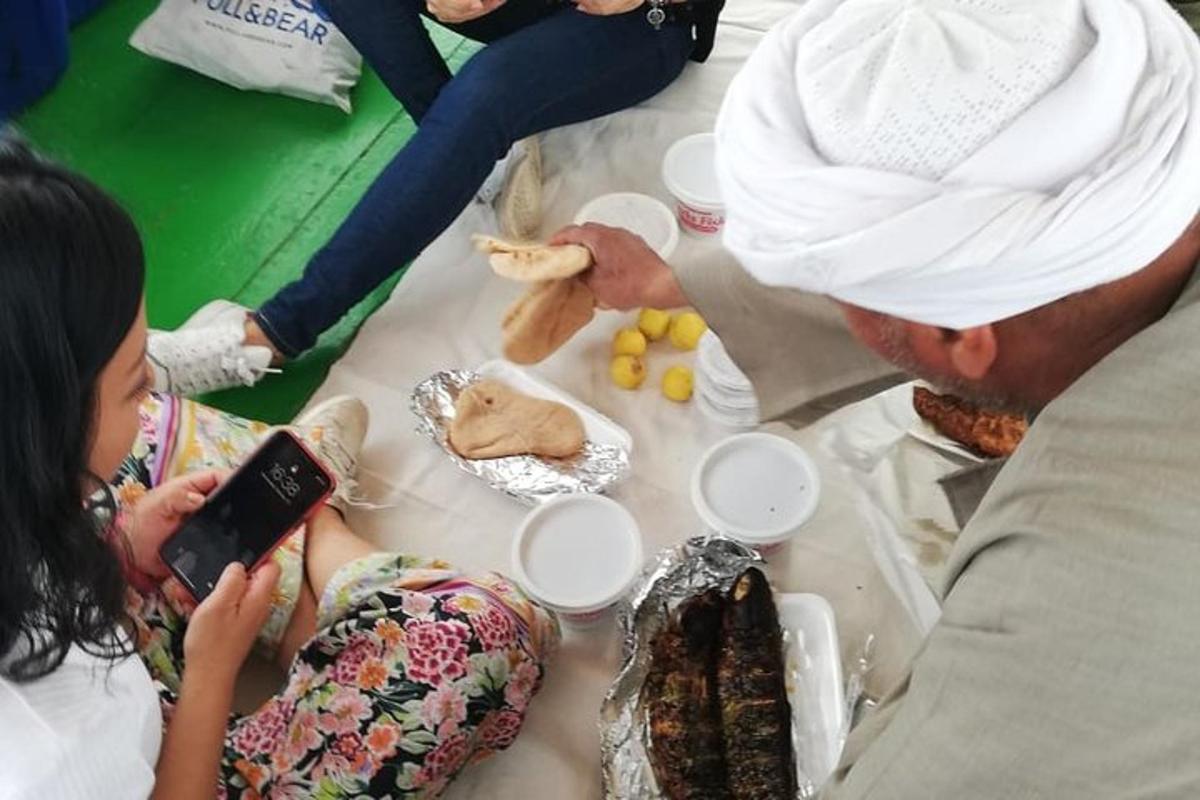 a woman taking a picture of a table with a chef