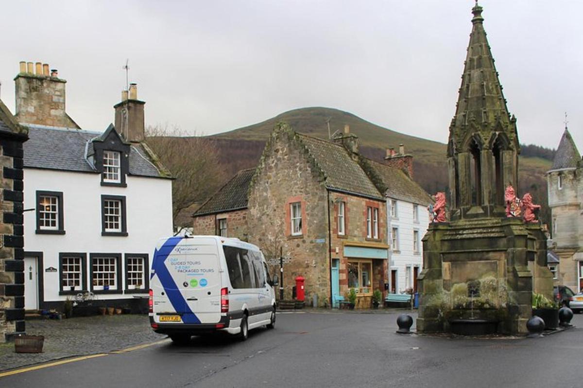 a white van driving down a street in a town