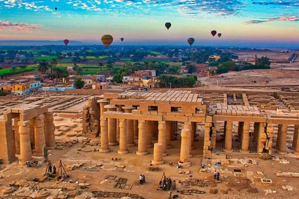 a group of hot air balloons flying over the ancientramids