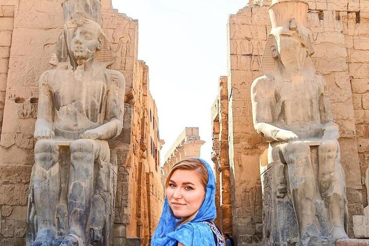 a woman standing in front of a statue