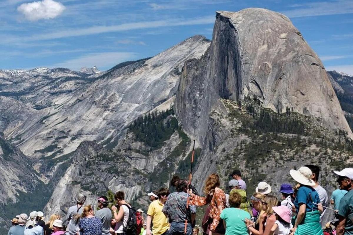 a group of people standing in front of a mountain