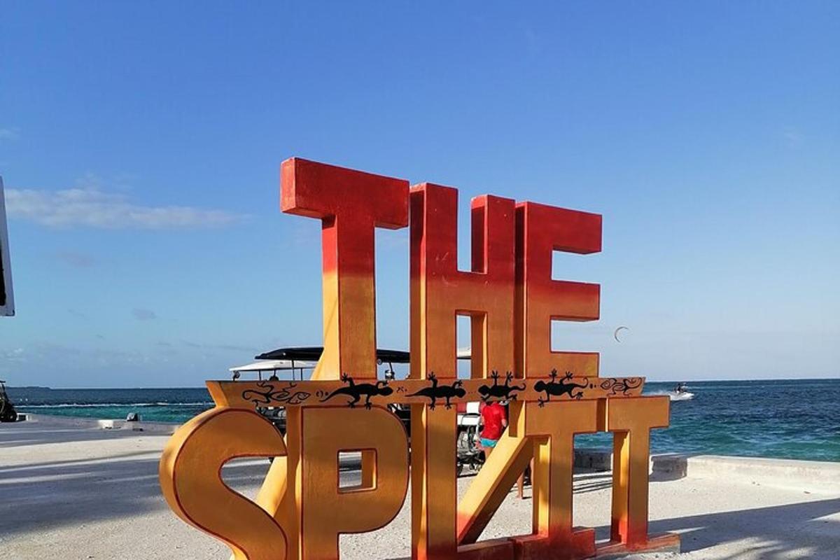 a large metal sign that says the end on the beach