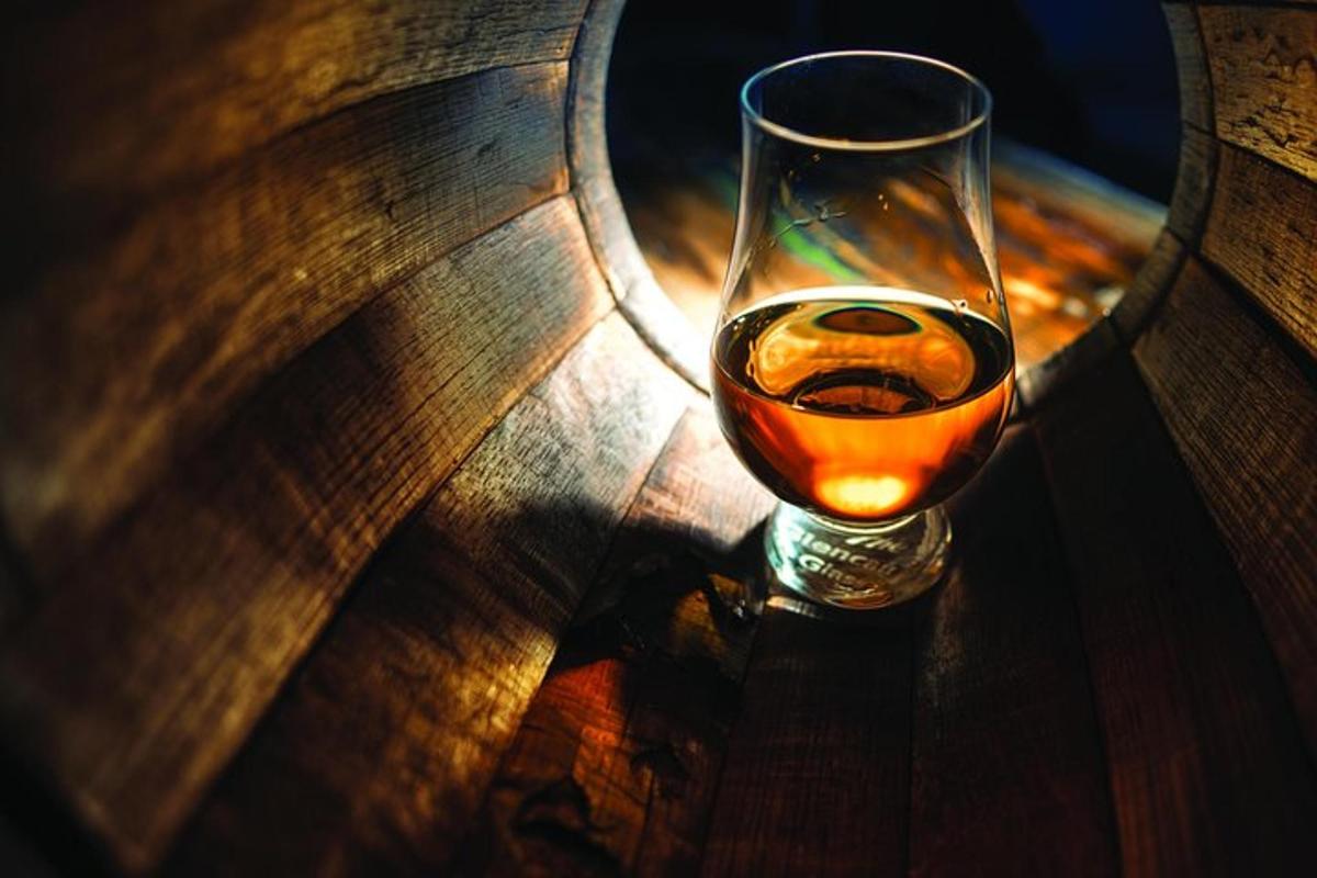 a wine glass sitting on top of a wooden table