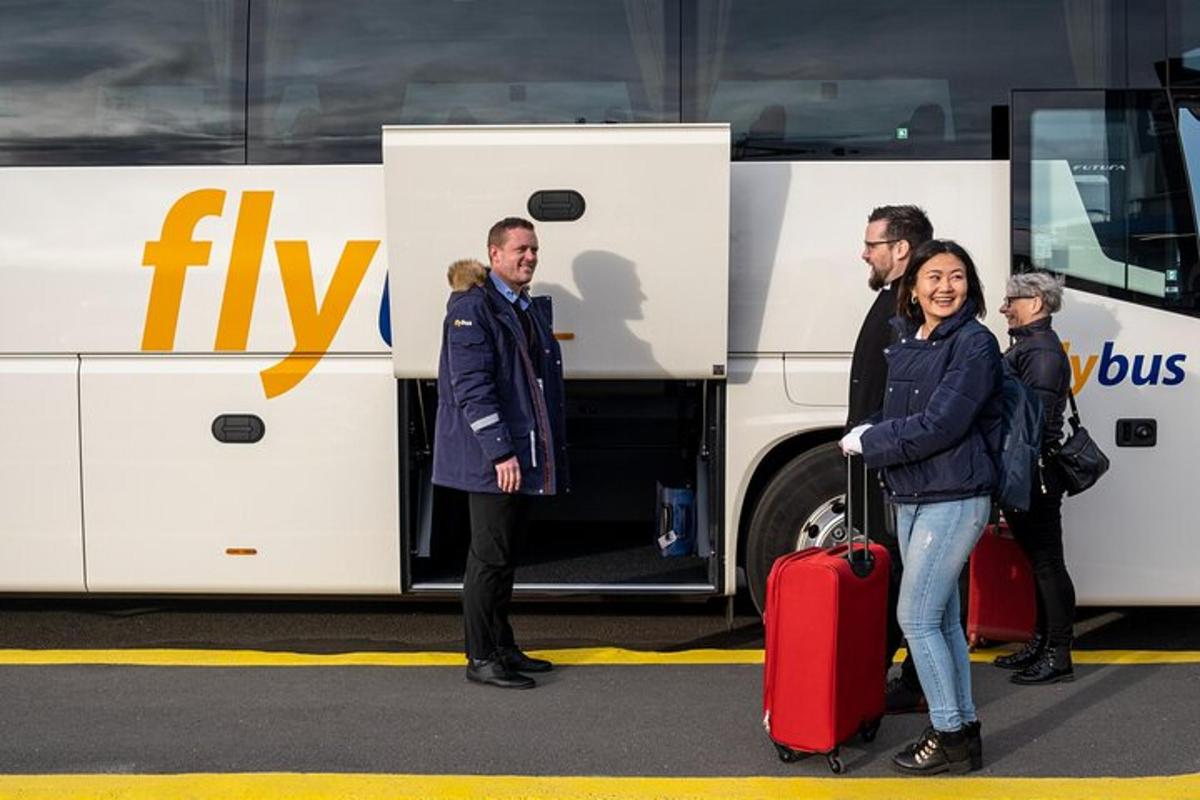 a group of people standing in front of a bus