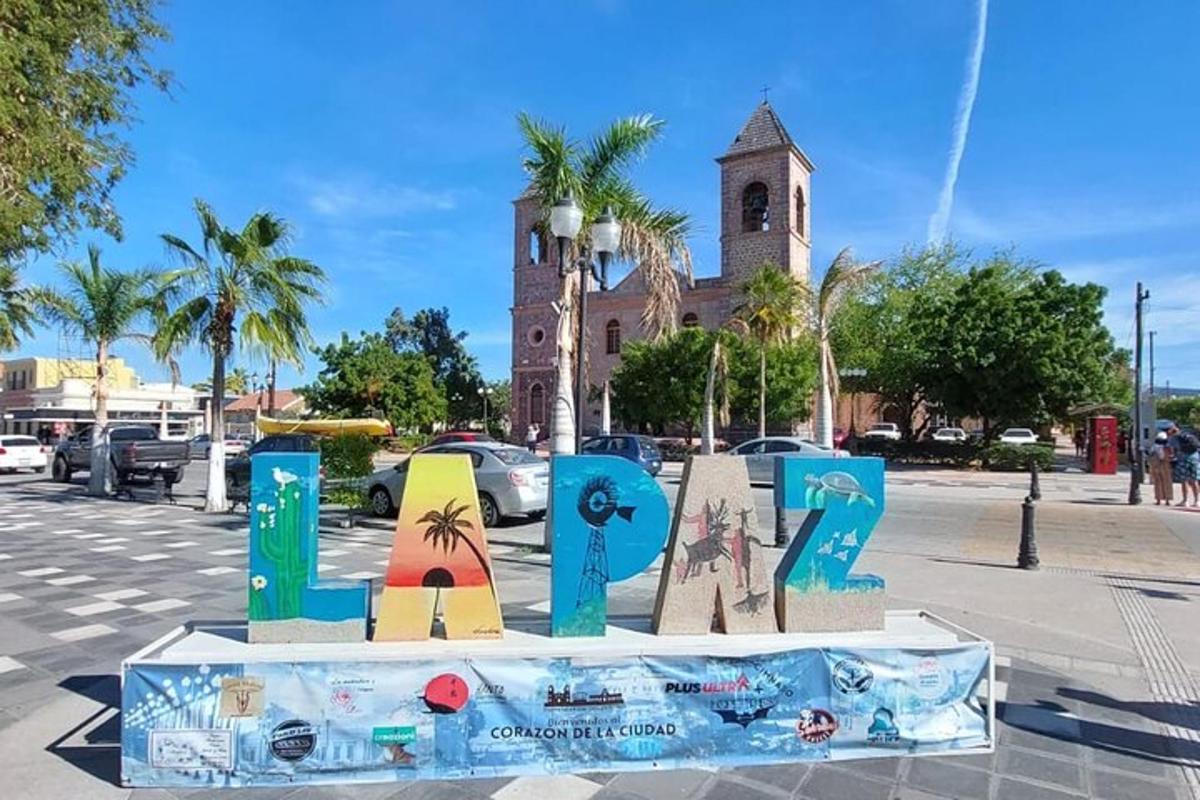 a sign in the street in front of a church