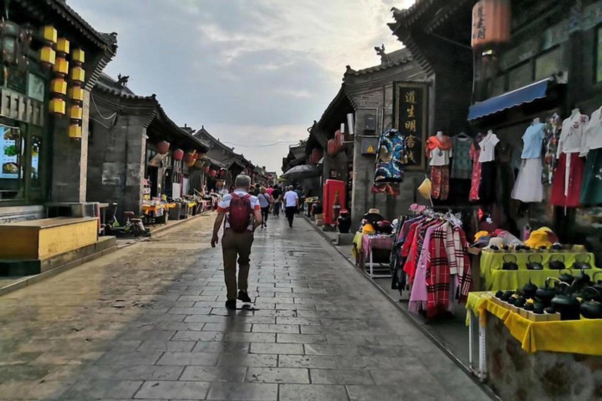a man walking down a street in a market