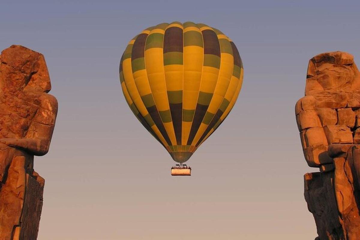 a yellow and black hot air balloon in the sky