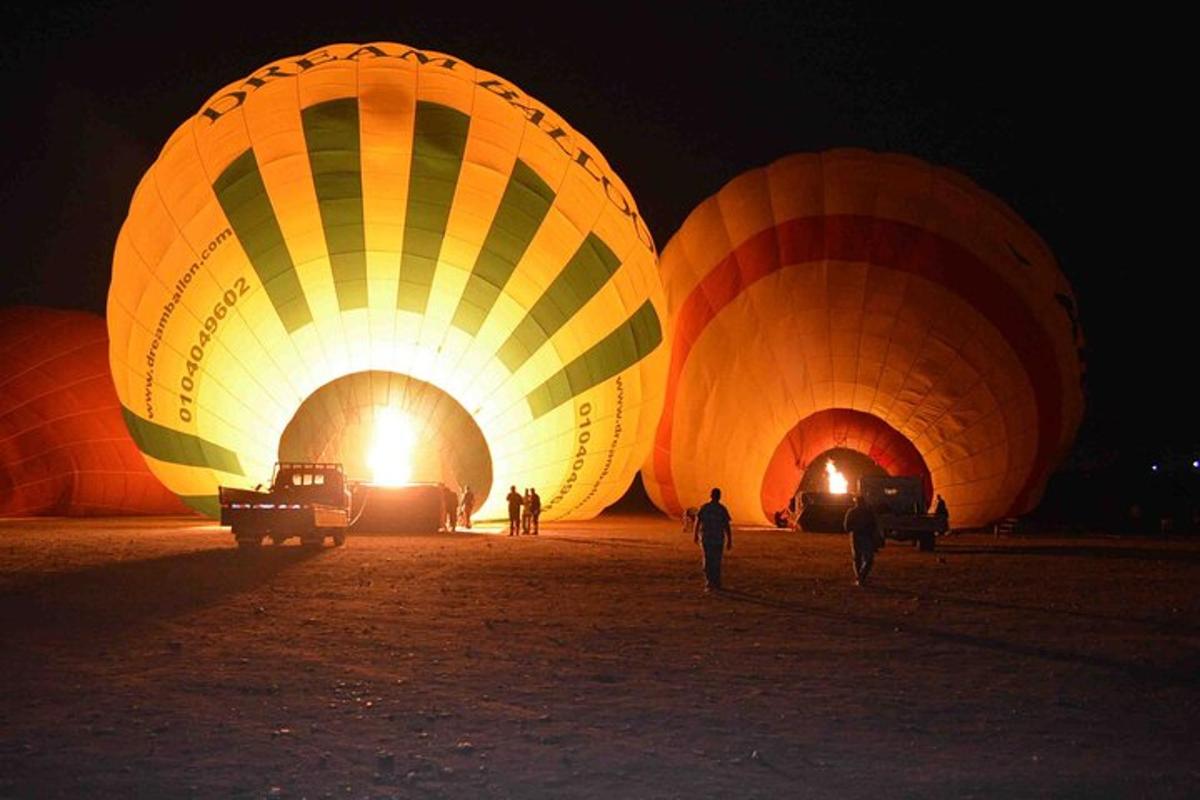 a group of hot air balloons are lit up at night