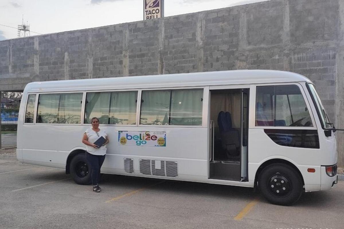 a woman standing in front of a white bus