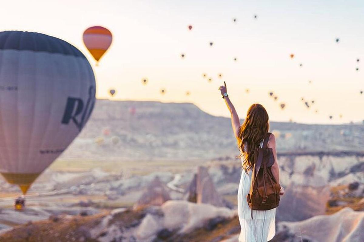 a woman flying a bunch of hot air balloons
