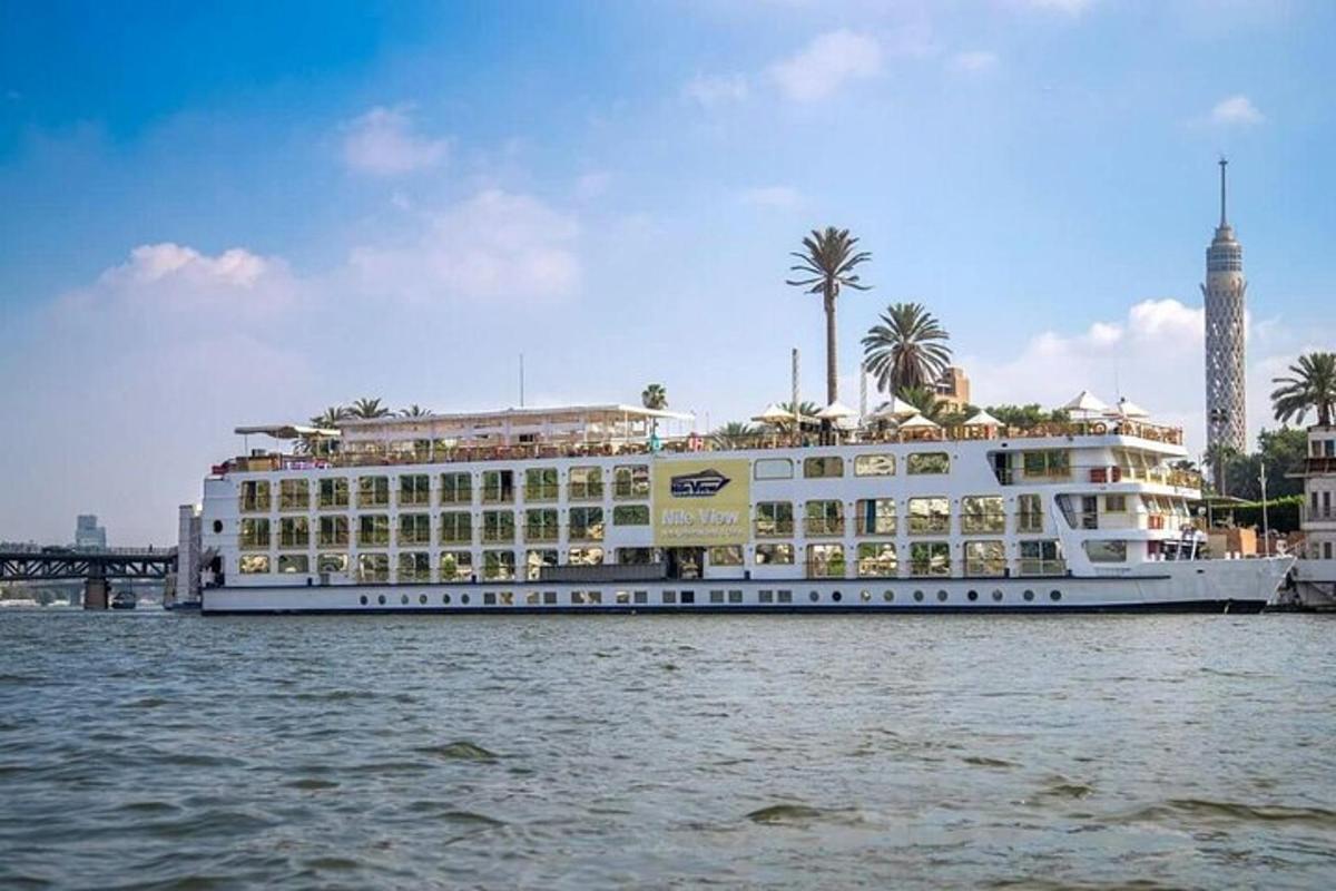 Un gran crucero en el agua junto a un edificio.