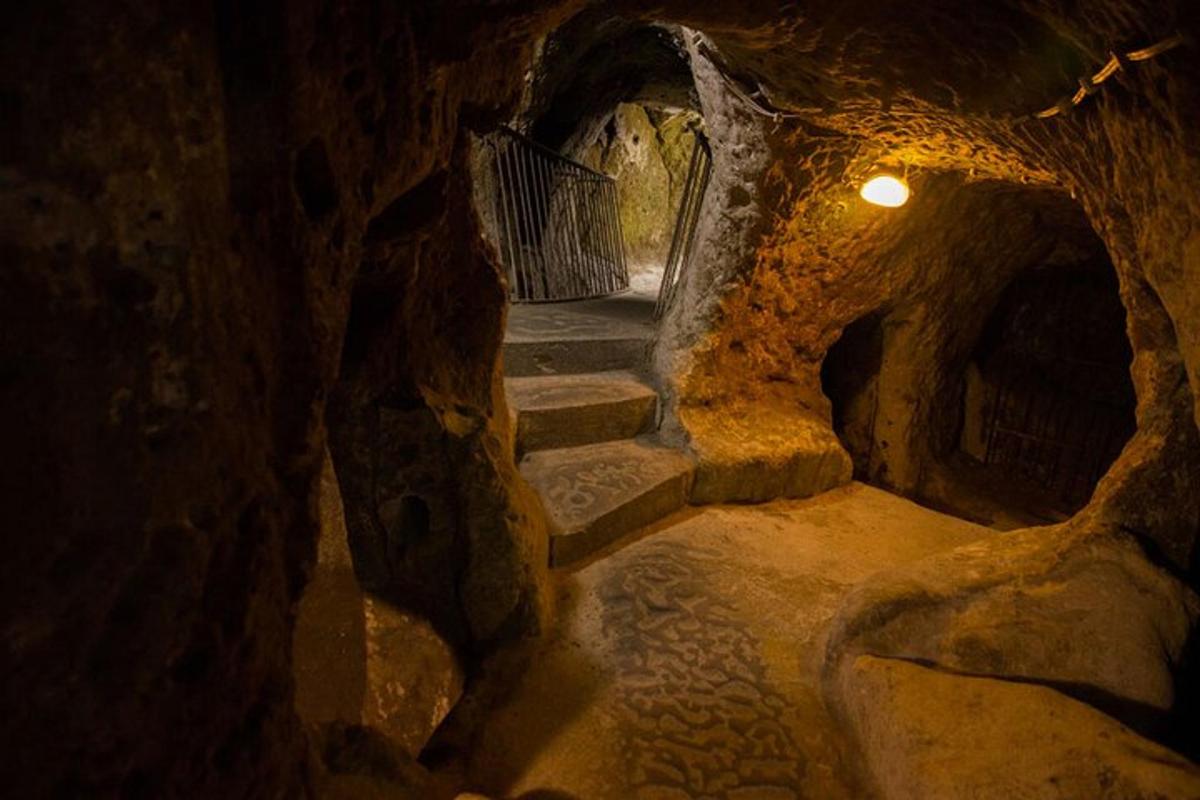 a cave with a stairway in a cave with rocks