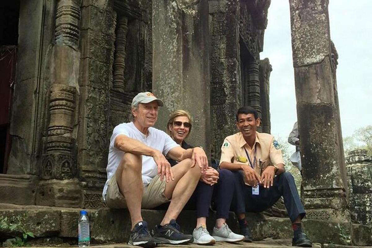 three people sitting in front of a temple