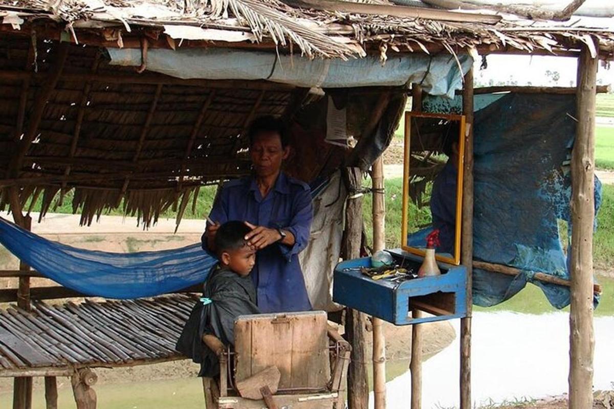 a man and a boy standing in a shack