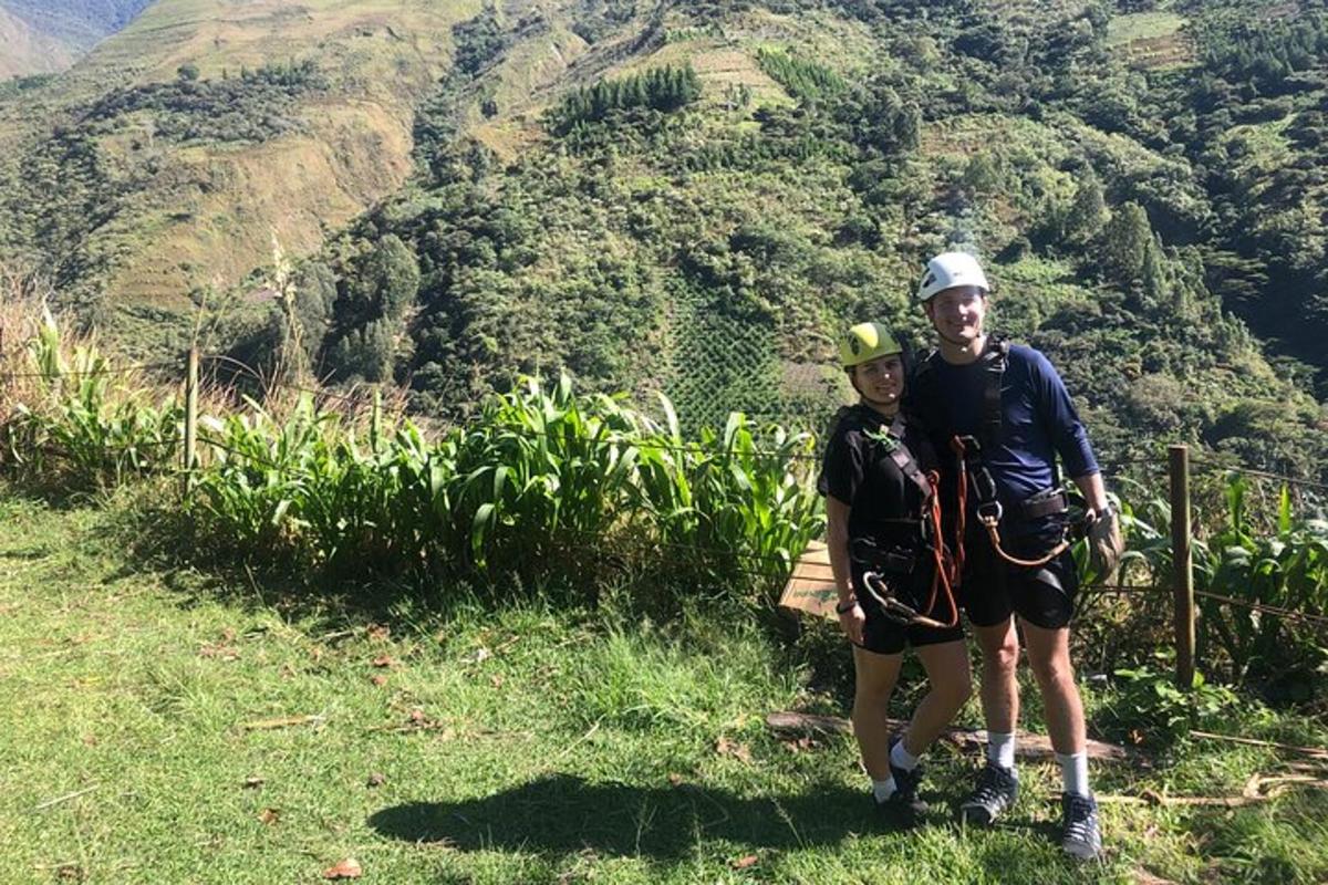 a man and a woman standing on the side of a mountain