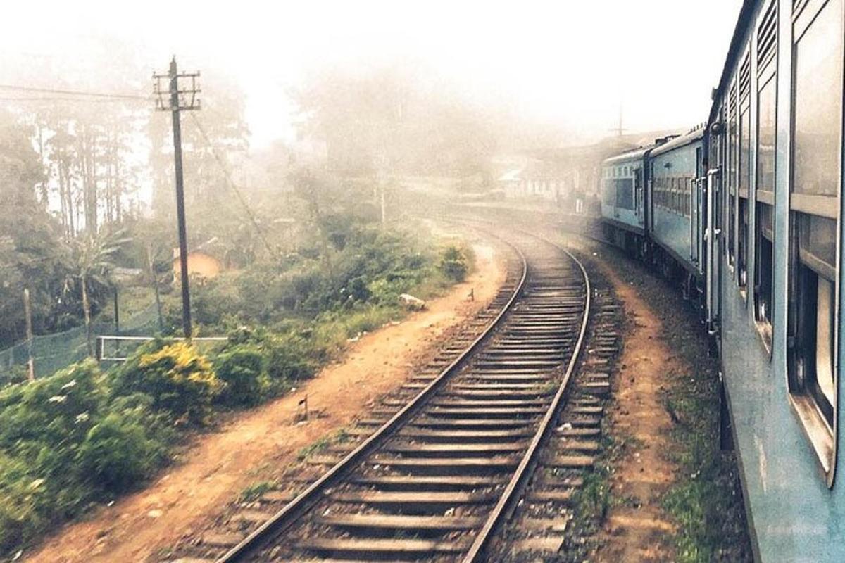 a train traveling down the tracks next to a train