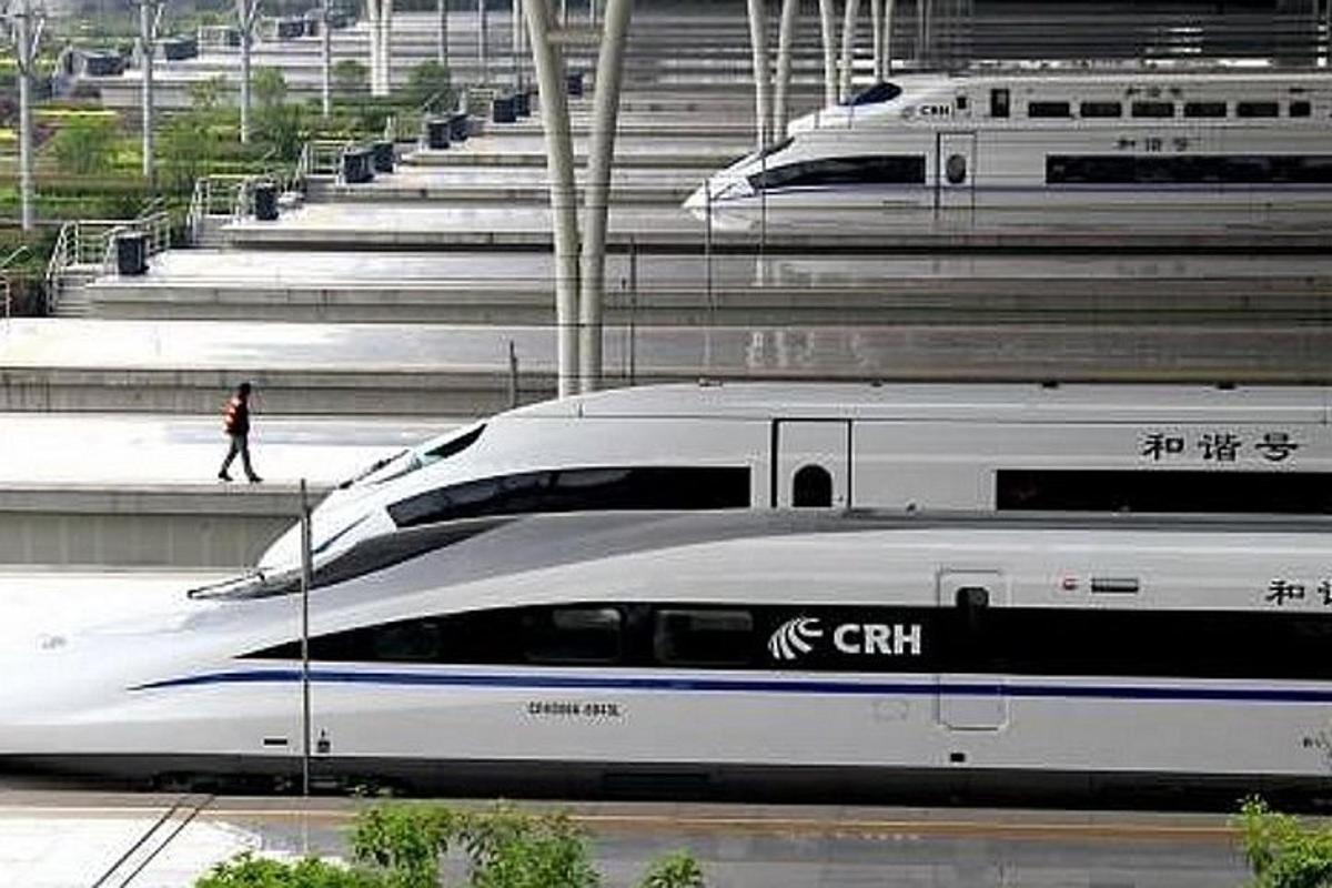 two bullet trains are parked next to each other