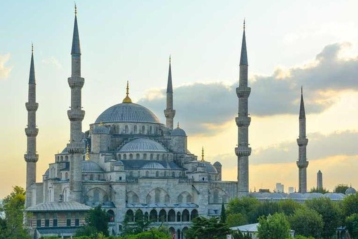 a large building with two blue domes and two mosques