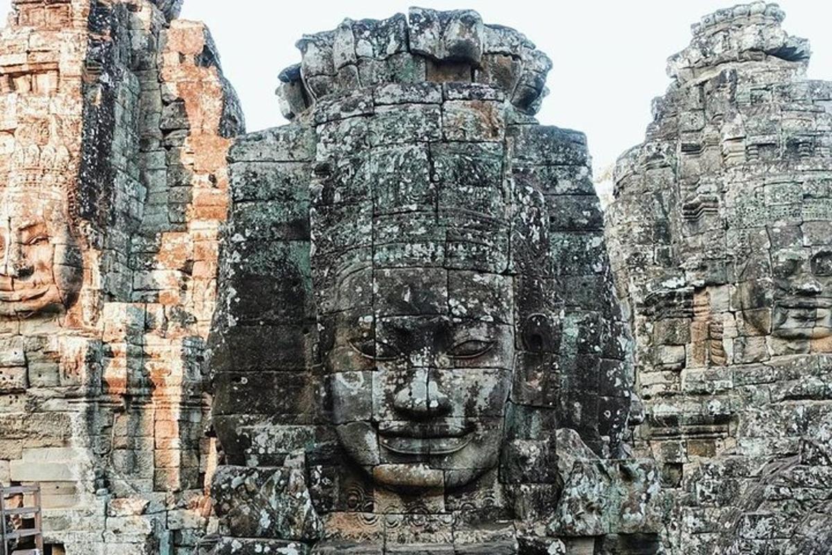 a statue of a face on the side of a building