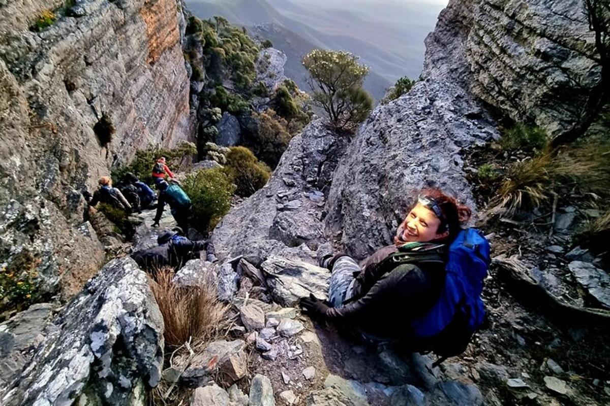 una mujer sentada en la ladera de una montaña
