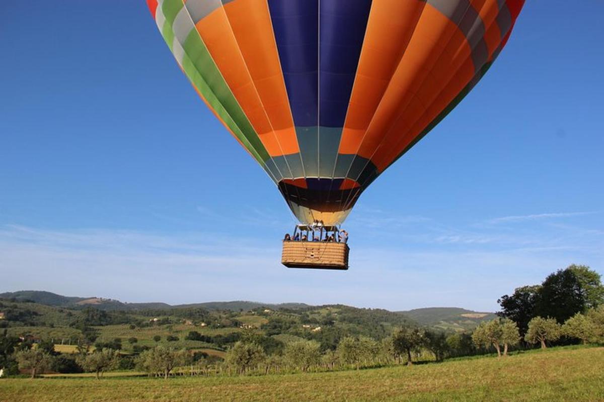 una mongolfiera che vola sopra un campo