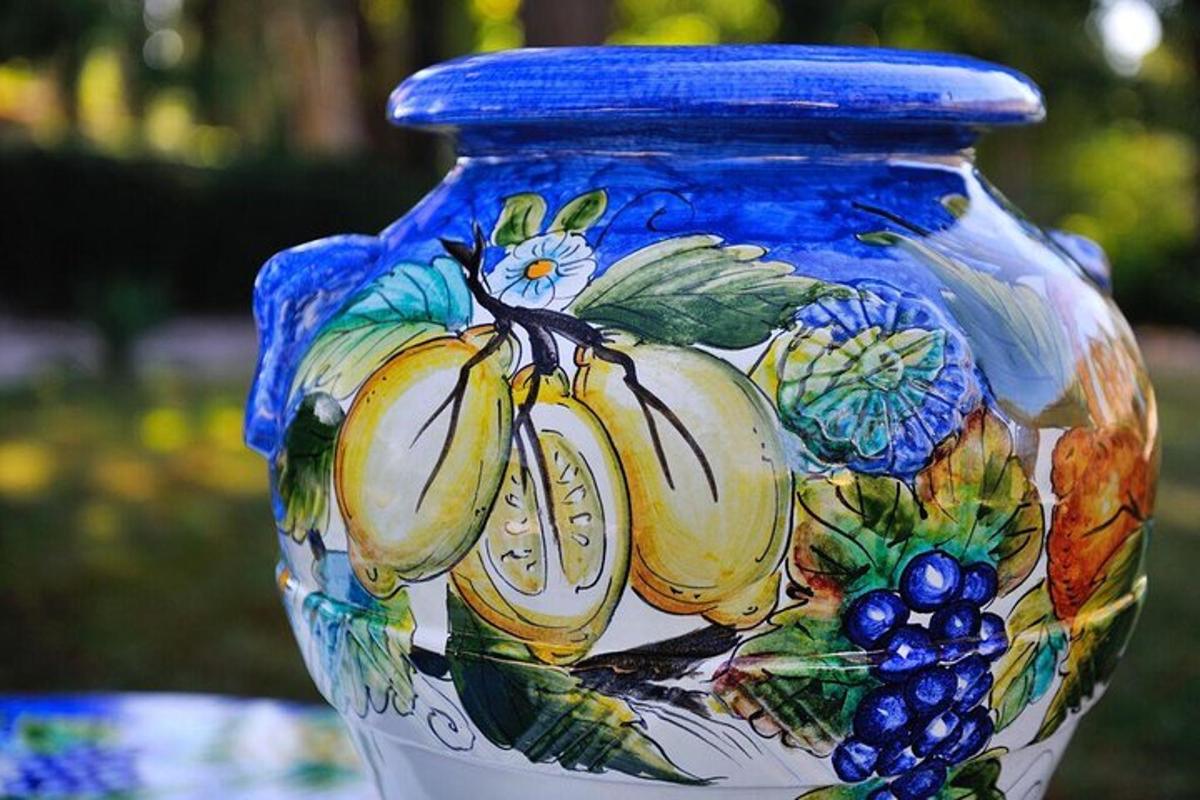a blue and white vase with fruit on it