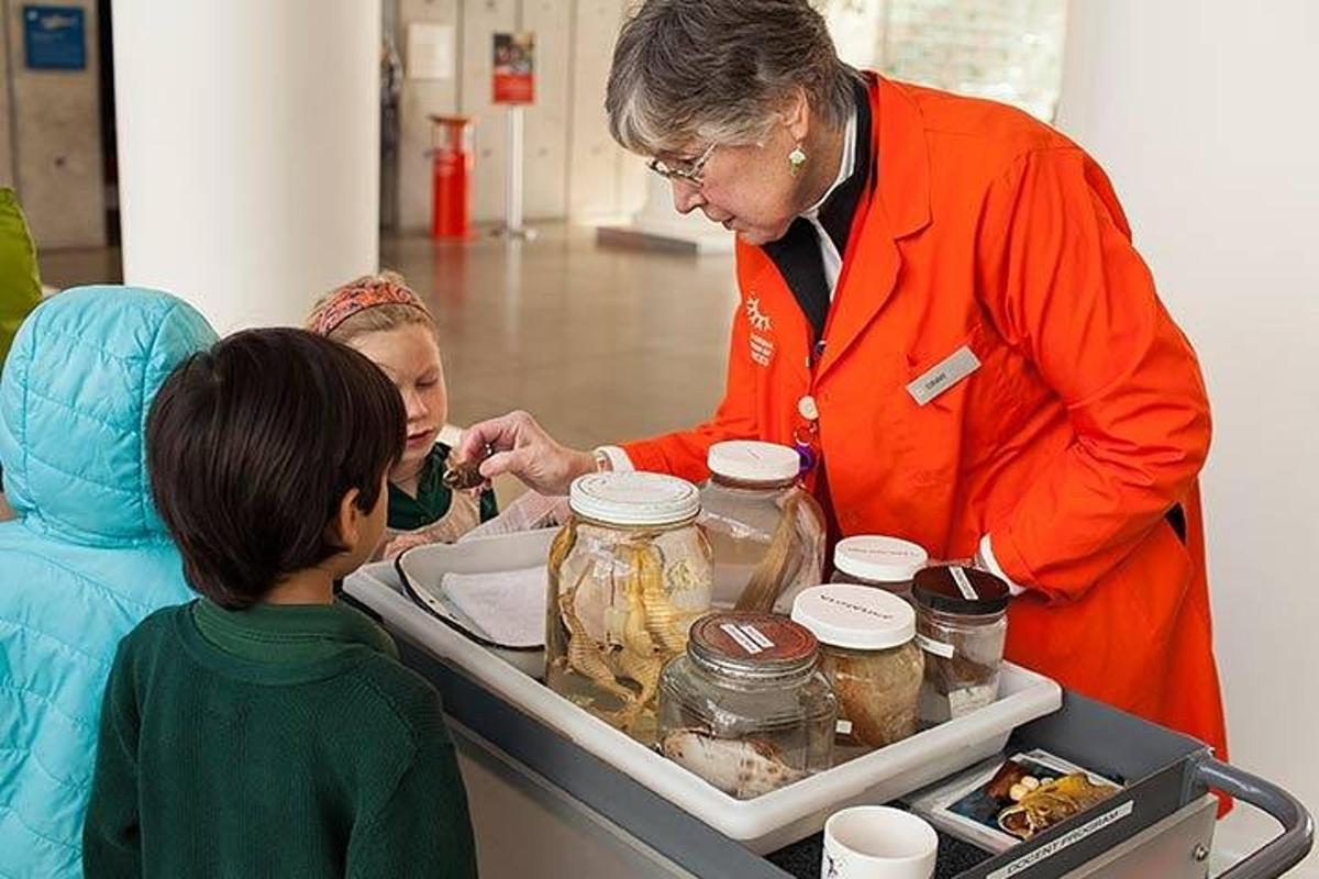 a woman feeding a child a jar of food