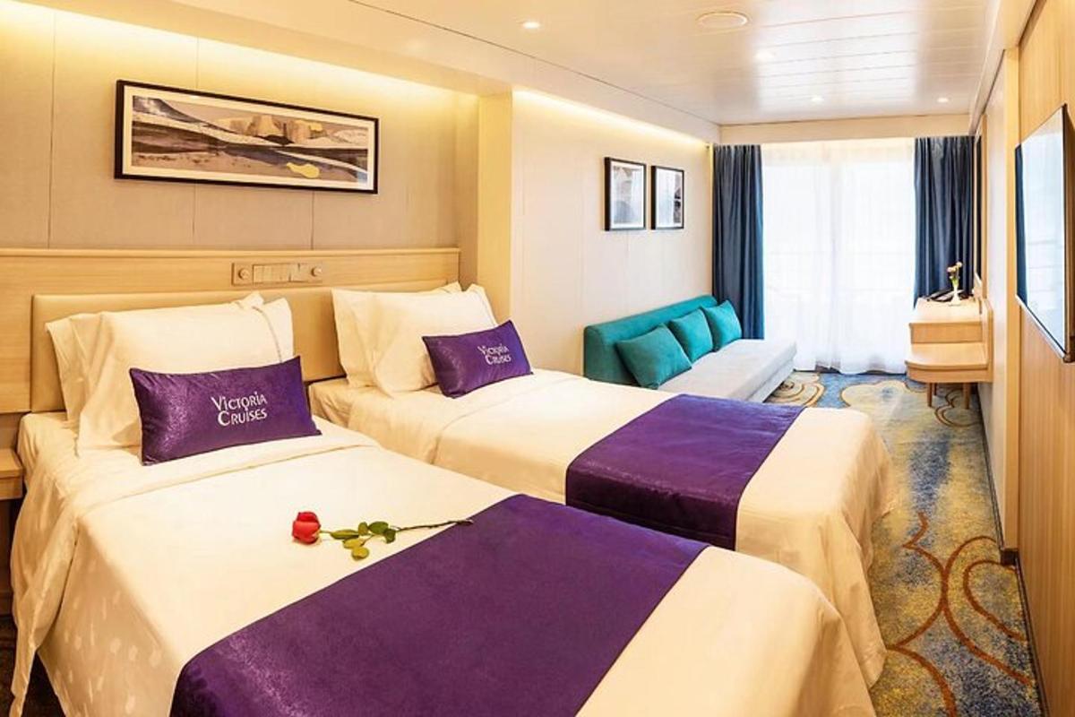 a hotel room with two beds and a blue chair