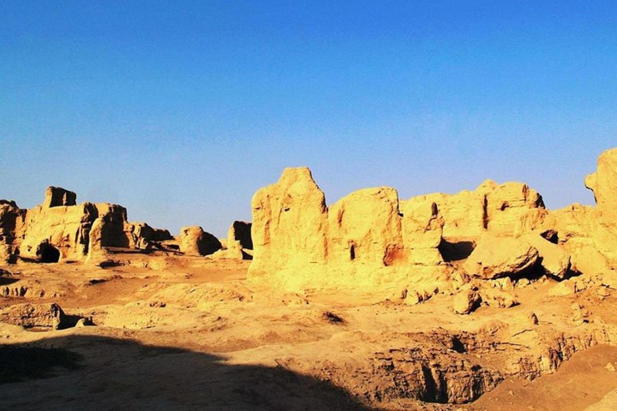 a view of a desert with some rock formations