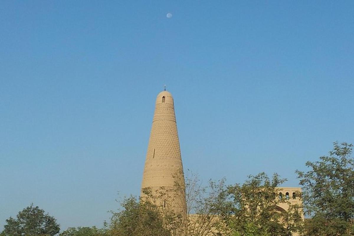 a tall brick tower in front of a blue sky