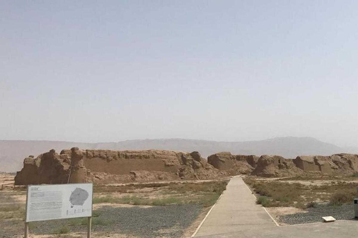a road in the desert with a sign and some rocks
