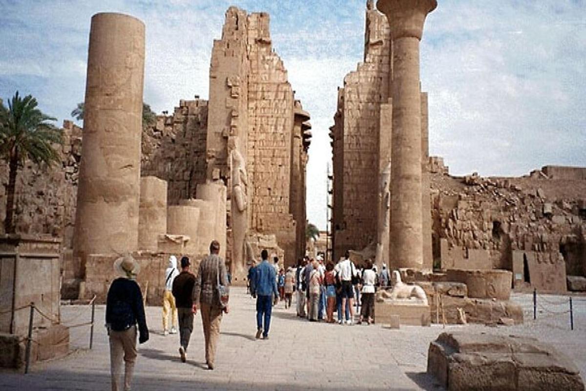 a group of people walking in front of a temple