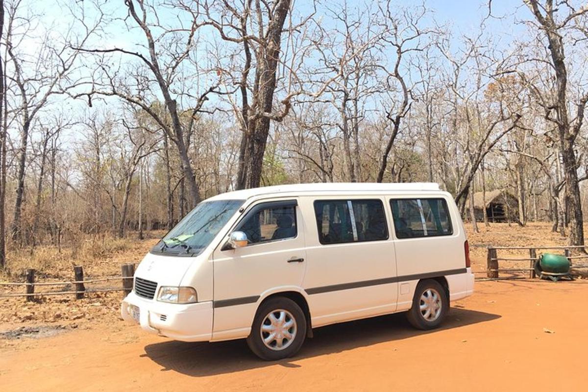 a white van parked on a dirt road