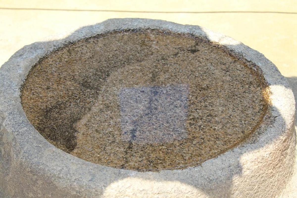 a manhole cover with a sign in the middle