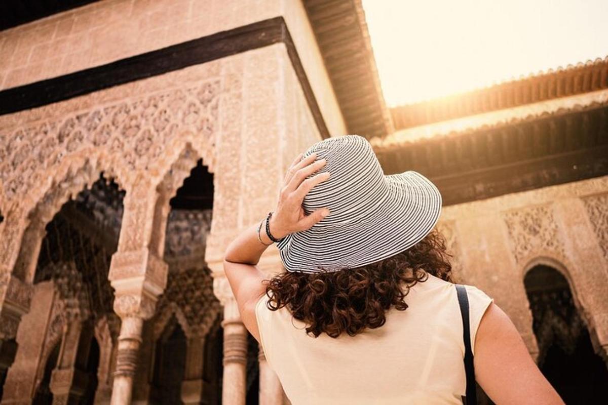 a woman wearing a hat in front of a building