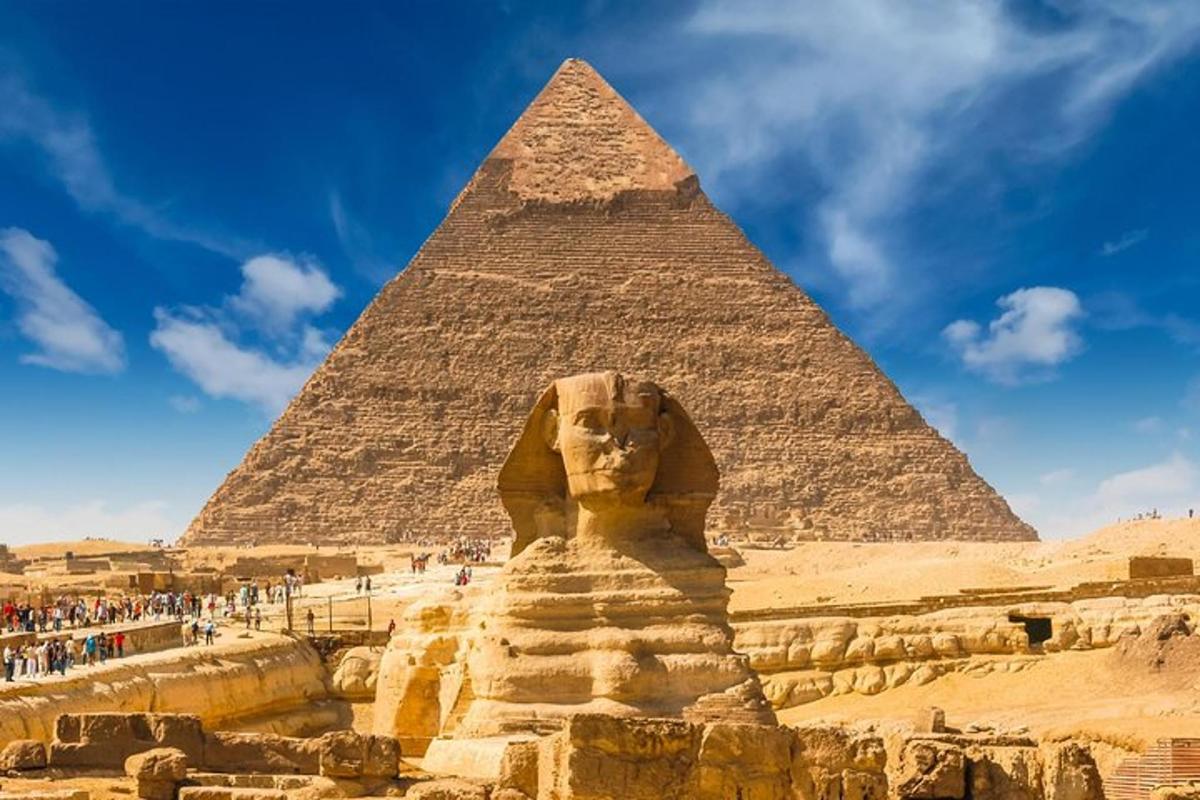 a statue in front of the pyramid