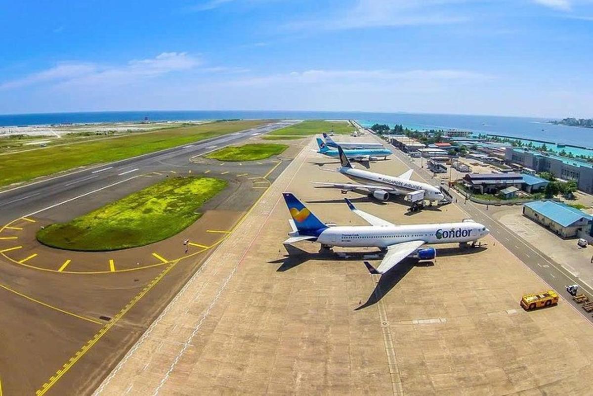 two airplanes are parked on a runway at an airport