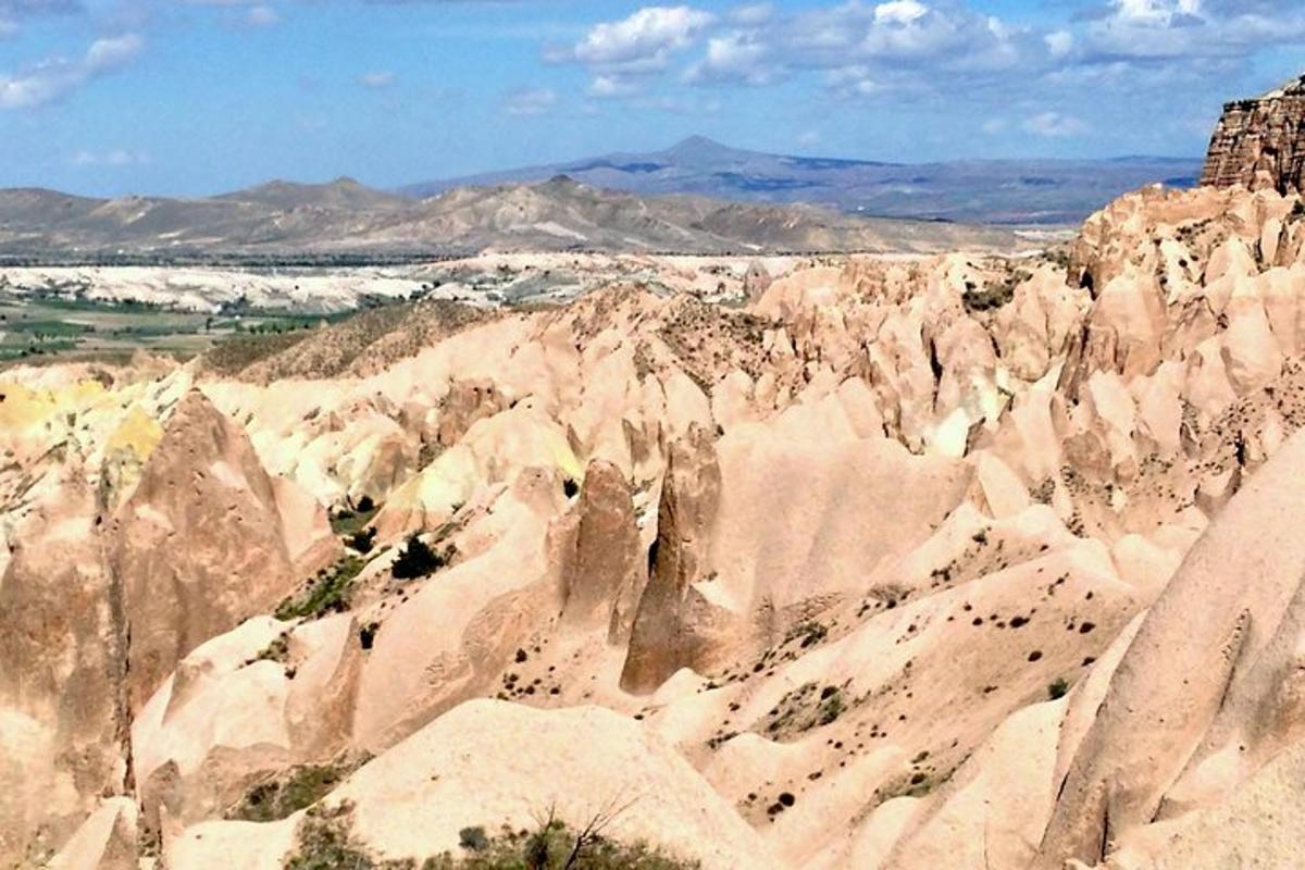 a view of a rocky mountain with mountains in the background