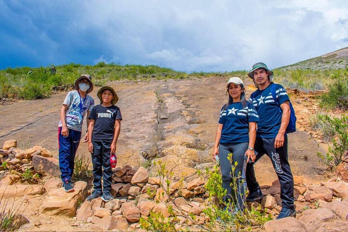 a group of people standing on a rocky trail