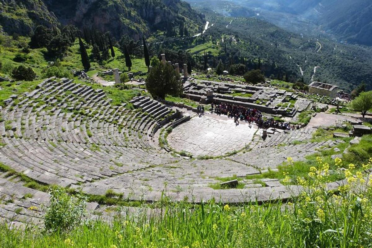 an amphitheater with people standing in it in the mountains